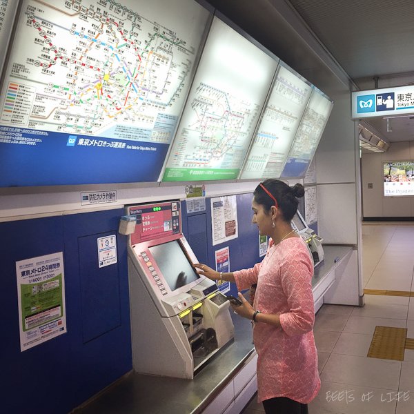 Buying train tickets at a station in Tokyo