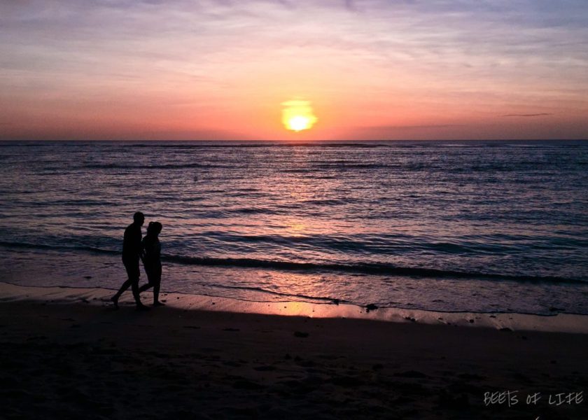 Sunsets in Mauritius: A couple strolling on the Flic en Flac beach
